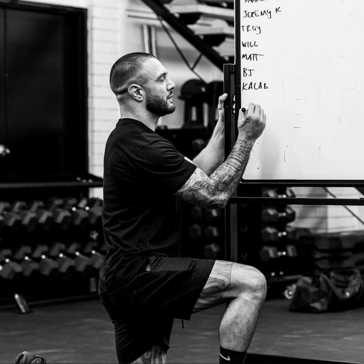 Benjamin writing training standards on the gym whiteboard